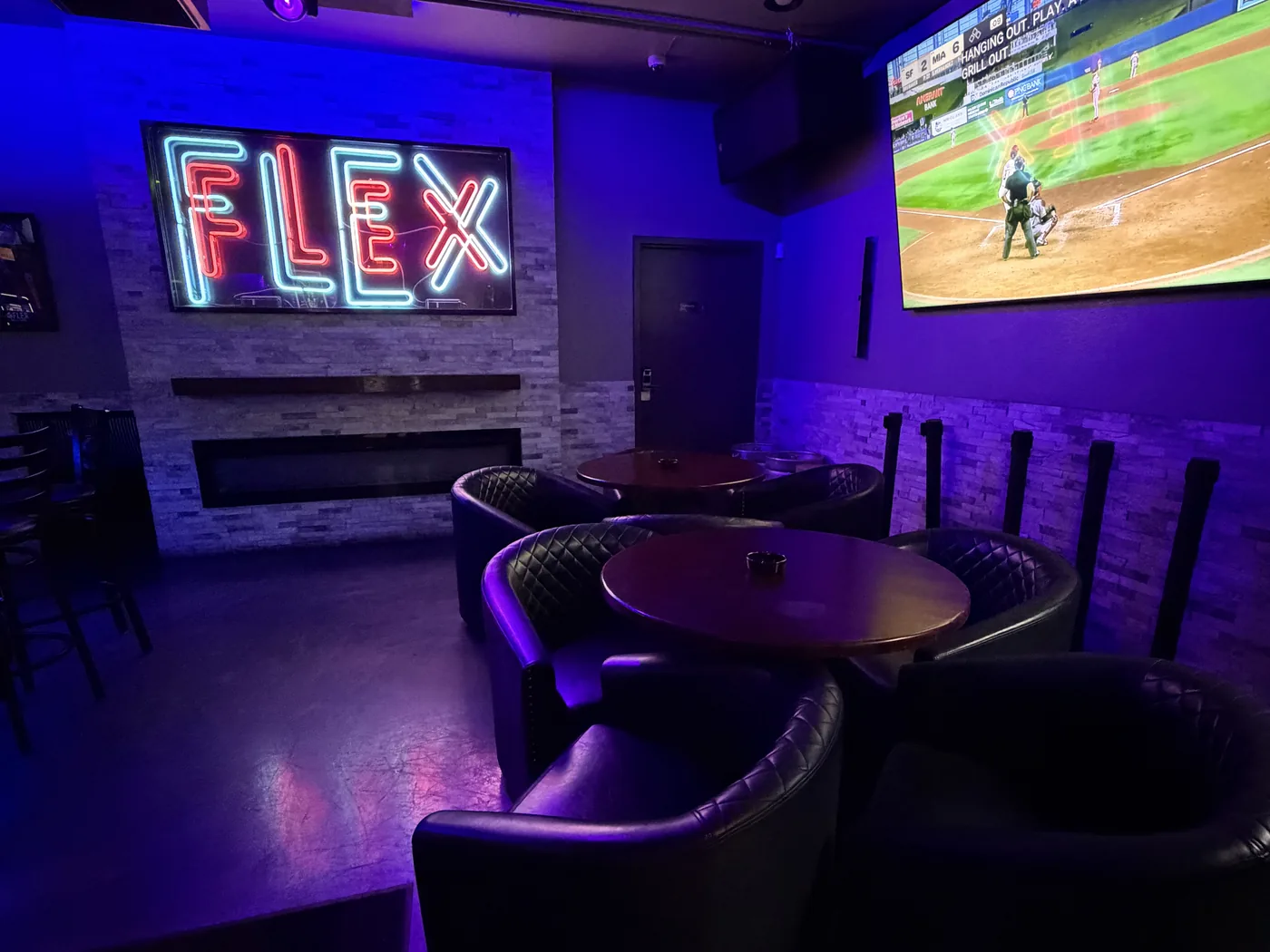 FLEX lounge seating with neon sign and big-screen TV